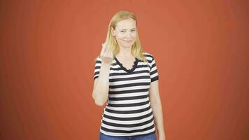 Woman making money sign with her hands. video