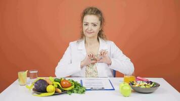 Nutritionist dietitian doctor makes heart on camera. Healthy lifestyle. video
