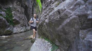 Free and peaceful young man in the creek in the canyon. video