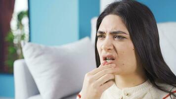 Young woman with braces hurts her teeth. video