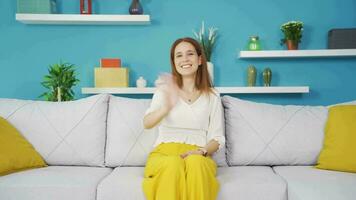 The young woman waving at the camera. video