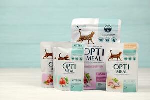 KHARKIV, UKRAINE - JANUARY 2, 2021 Optimeal cat meal packs. Optimeal is product by Kormotech LLC, a global family company, the largest producer of pet food in Ukraine photo