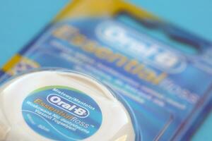 KYIV, UKRAINE - JULY 7, 2023 Oral-B Essentail Floss. Waxed dental floss in round case photo