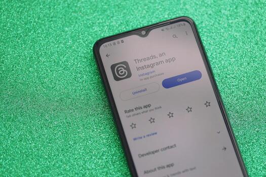 KYIV, UKRAINE - JULY 7, 2023 Threads by Meta application on display of Samsung smartphone lying on table photo
