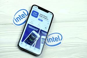 KHARKOV, UKRAINE - MARCH 5, 2021 Intel icon and application from App store on iPhone 12 pro display screen on white table photo