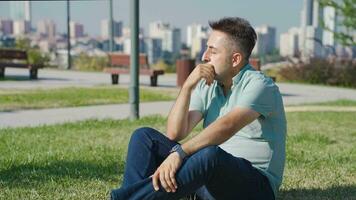 Emotional man sitting outdoors. video