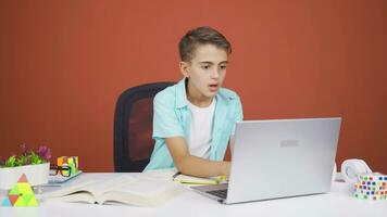 Boy looking at laptop gets frustrated. video