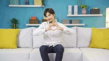 Man making heart symbol for camera. video