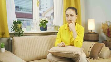 Worried and nervous woman at home watching outside. video