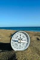 Compass in sand photo