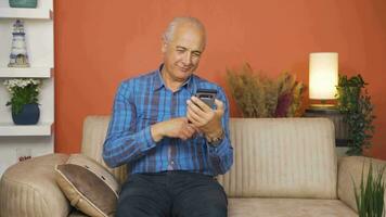 Man using phone with happy expression. The man is enjoying it. video