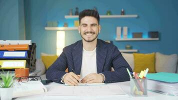 Businessman looking at camera and laughing. He is making a positive gesture. video