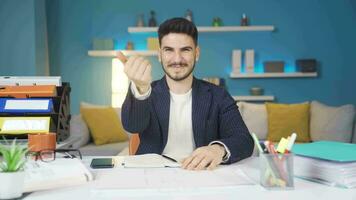 Home office worker looking at the camera and calling the other person to himself. video