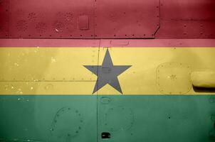 Ghana flag depicted on side part of military armored helicopter closeup. Army forces aircraft conceptual background photo