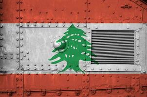 Lebanon flag depicted on side part of military armored tank closeup. Army forces conceptual background photo