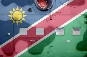 Namibia flag depicted on side part of military armored helicopter closeup. Army forces aircraft conceptual background photo