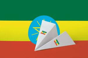 Ethiopia flag depicted on paper origami airplane. Handmade arts concept photo