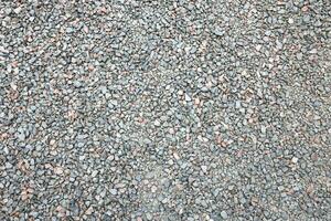 Close up of muddy puddle with small stones on wet surface. Background texture with top view photo