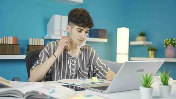 The student talking on the phone while studying at home is angry. video