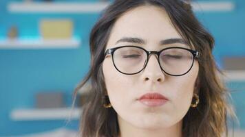 Young woman wearing glasses is thinking. video