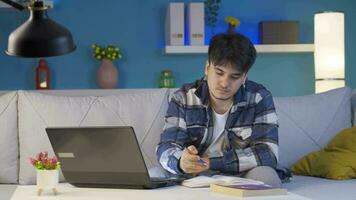 Successful student looks at the camera with a smile while studying at home. video