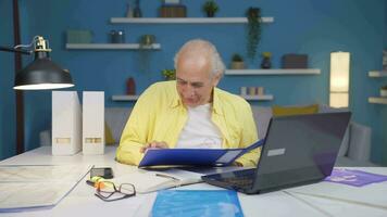 Home office worker man looking at paperwork files. video