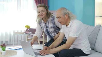 Woman bringing coffee to her home office worker husband at home. video