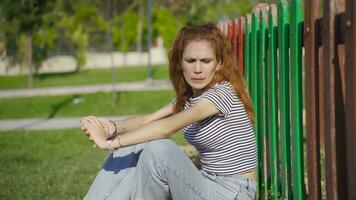 Young woman sitting on the ground in panic. video