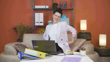 Home office worker woman has lower back pain. video