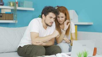 Married couple watching horror movie on laptop at home. video