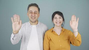 Couple waving at camera. video