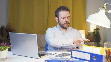 Home office worker man reviewing paperwork files. video