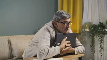 Old man joyfully embracing laptop. video