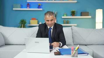 Home office worker man looking emotional at camera. video