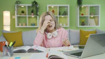 University student girl who has a headache while studying. video