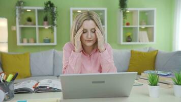 University student girl is upset by what she sees on laptop. video