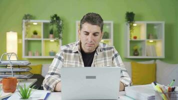 Man counting money in his home office. video