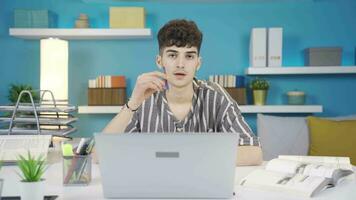 Student tired of lecture. Looks at camera and makes negative gesture. video