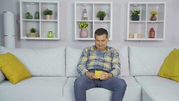 The old man opens the gift box he received from his children and is very happy. video