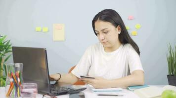 Female student doing e-commerce shopping. video