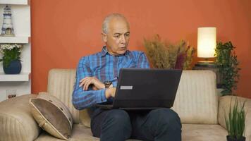 Man watching movie on laptop with happy expression. video