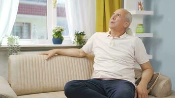 Happy and peaceful man. He is sitting in front of the window. video