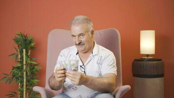 Man counting money looking at camera. video