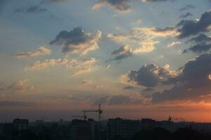 Beautiful sunrise with warm orange sunlight and beams through blue sky photo