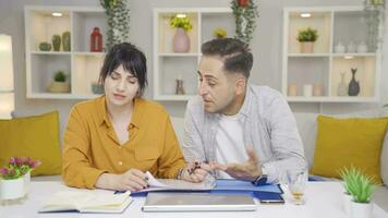 The couple looking at the file and getting angry gets angry at the file. video