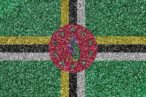 Dominica flag depicted on many small shiny sequins. Colorful festival background for party photo