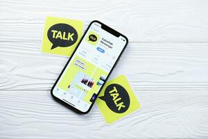 KHARKOV, UKRAINE - MARCH 5, 2021 KakaoTalk Messenger icon and application from App store on iPhone 12 pro display screen on white table photo