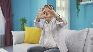 Man making heart sign at camera. video