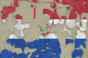 Paraguay flag depicted in paint colors on old obsolete messy concrete wall closeup. Textured banner on rough background photo