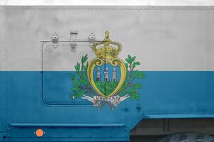 San Marino flag depicted on side part of military armored truck closeup. Army forces conceptual background photo